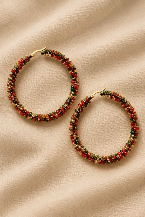 Multicolor beaded hoop earrings on a champagne-beige background